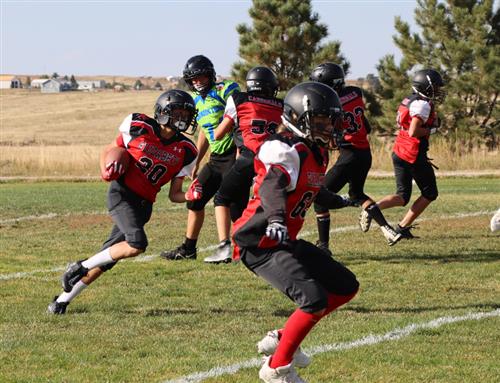 EMS football players execute a running play